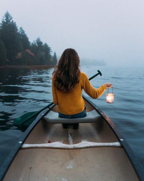 Girl in a canoe with a lantern