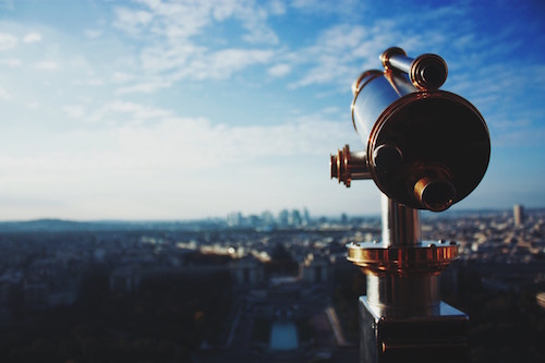 Telescope overlooking a city. Photo by Krissana Porto on Unsplash