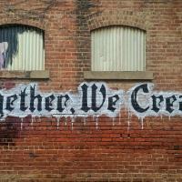Together we create graffiti on brick wall