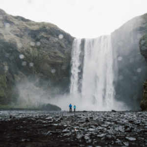 People standing in front of waterfall