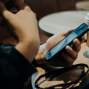 Person on their phone in coffee shop