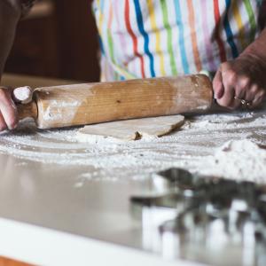 Person rolling pastry on counter