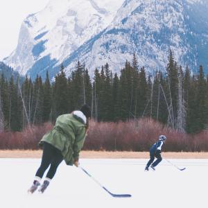 Kids playing hockey on frozen lake in Banff