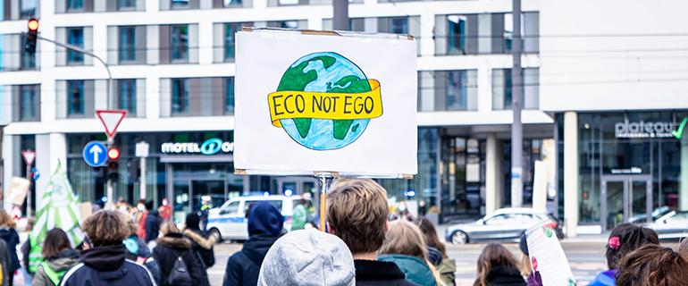 Image Credit: Mika Baumeister from Unsplash of climate protest