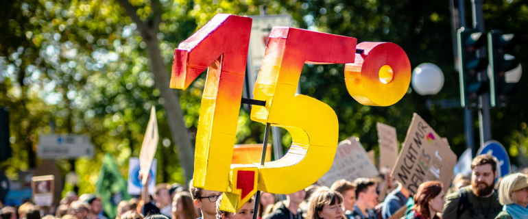 Climate protest sign of 1.5 degrees global warming threshold set by the Paris Agreement